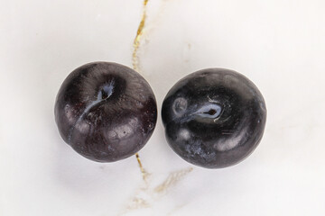 Two ripe sweet black plums