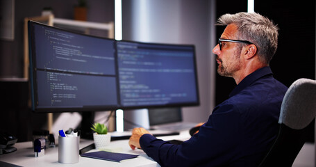 Coder Using Computer At Desk