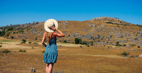 Fototapeta premium Woman looking wilderness landscape- Lozere in France