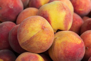 Sweet fruit. Peach on the market counter for sale.