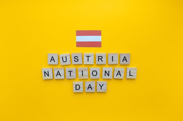 October 26, Austrian National Day, flag of Austria, minimalistic banner with wooden letters on an orange background