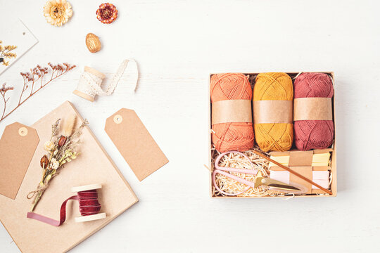 Preparing gift box for knitting lovers. Plastic free zero waste care package. Personalized eco friendly basket for family and friends for autumn holidays, christmas, mothers day
