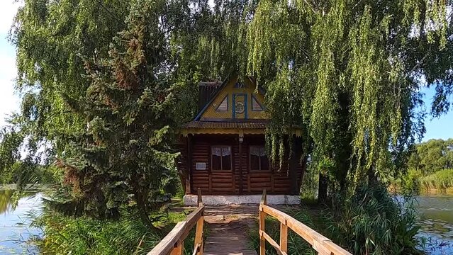 Fisherman's house on a tiny island in the middle of the lake on summer. Old Solotvyn village, Ukraine.