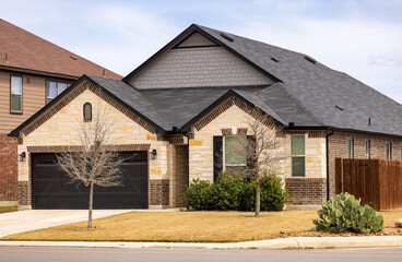 Single family house exterior, American style, with cacti and dried up lawn, specific for southern Texas