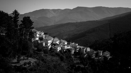 Fototapeta na wymiar View of village in the foothills of Serra da Estrela, Portugal. Black and white photo.
