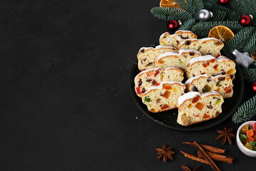 Traditional German Christmas cake , Stollen with decoration and spices. dark background, top view, copy space