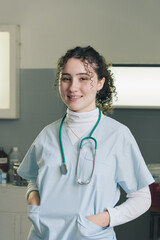 Medical student. Woman hospital worker looking at camera and smiling.