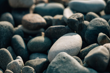 Fototapeta na wymiar Background wet pebbles. The texture of polished sea stones. Close-up.