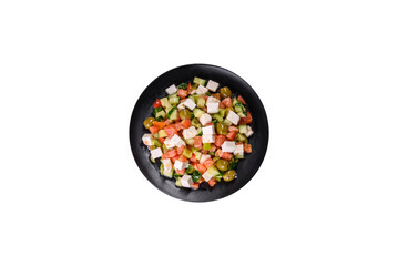 Greek salad with juicy tomatoes, feta cheese, lettuce, green olives, cucumber, red onion and fresh parsley