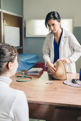 Gynecological doctor teaching breast self-examination.