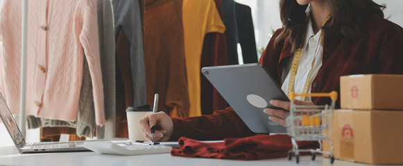 Portrait young attractive hipster asia female owner startup look at camera work happy with box at home prepare parcel delivery in sme supply chain, procurement, omnichannel ecommerce online concept.