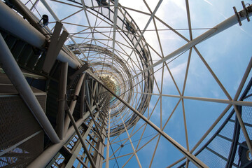 Big metal architectural construction on sky background, view from the bottom