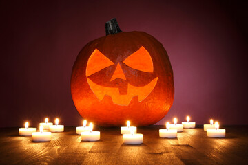 Pumpkin on a red background with candles