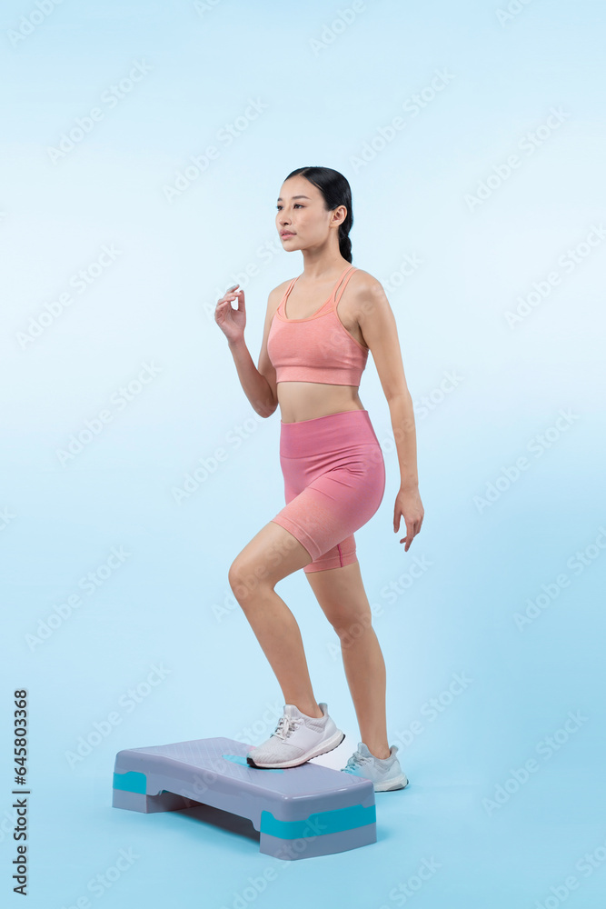 Wall mural vigorous energetic woman doing exercise at on studio short isolated background with cardio aerobic s