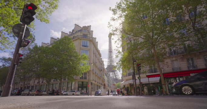 Time lapse. Romantic cozy view of the famous Eiffel tower from a small Paris street wide horizontal panorama. Camera fixed position