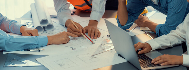Architect or engineer working on building blueprint, contractor designing and drawing blueprint layout with tool for construction project. Civil engineer and architecture design concept. Insight