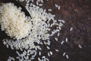 Close-up of a Spoon of Uncooked Arborio Rice on a Dark Background