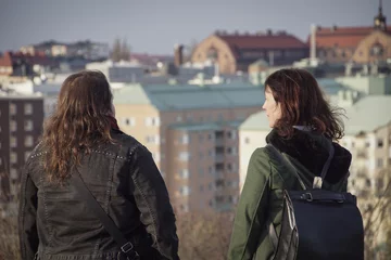 Foto op Plexiglas Rear view of two woman against buildings © niklas storm