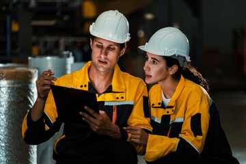 Two factory workers or engineers conduct professional inspection on machine or procedure in chemical plant, chemistry factory workplace and industrial profession concept. Exemplifying