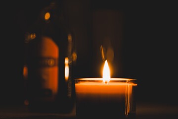 Closeup shot of a lit candle in the darkness