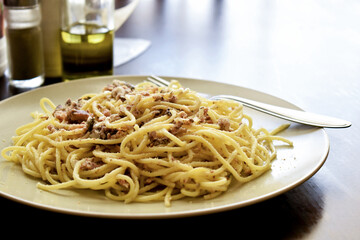 Pasta sardines with a fork on a plate.  Italian food style.