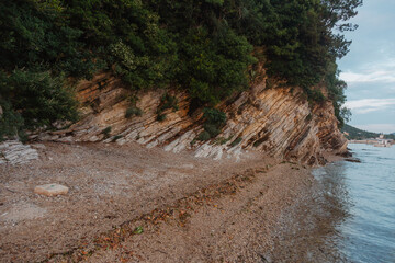 rocky mountain coast descends to a sea bay at sunset in Montenegro