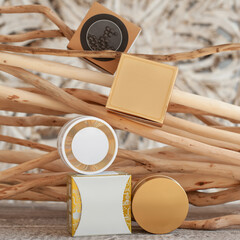 set of beige jars for cream and cosmetics on a background of wooden branches