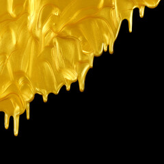 Glittering shiny metallic gold paint flowing and dripping downward. Isolated on black.