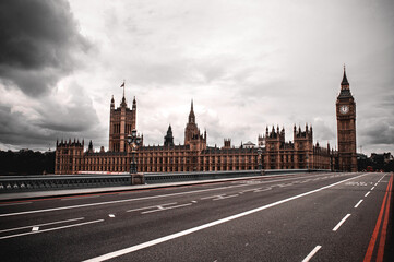 Fototapeta na wymiar London, Great Britain - July 18, 2012: Empty Westminster Bridge with clock tower and Big Ben. Parliament building with flag and rainy clouds.