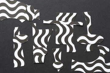 overlapping black and white paper shapes (circles) on black 