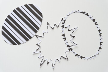 machine-cut paper shapes (oval, and two types of star burst rings) on blank paper