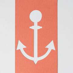 anchor shape silhouette machine-cut from orange pastel or coral orange pastel card stock and arranged on blank paper © eugen