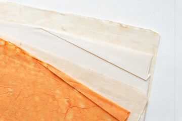 paper textures (some with folded or creased edges) layered on blank paper