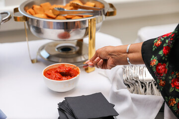 hand delicately savoring food, representing the joy and sensory pleasure of culinary indulgence