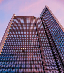 modern office building with only a few windows have light at dusk in Frankfurt am Main