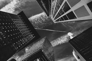 Foto op Canvas black and white architecture of the city with high-rises and a cloudy sky  © PHAT