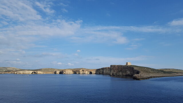 A vast ocean expanse, sparkling in the sunlight, cradles a minuscule island, a verdant oasis, in its midst, Malta, Europe