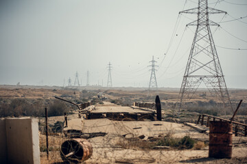 King Hussein Bridge: barbed wire, a damaged bridge and a long row of electric poles