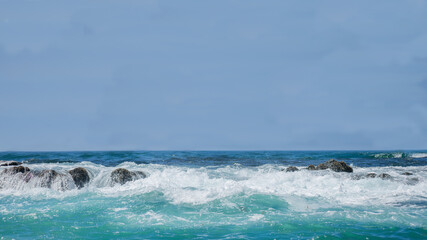 Seascape with gem blue waters running over rocks - banner