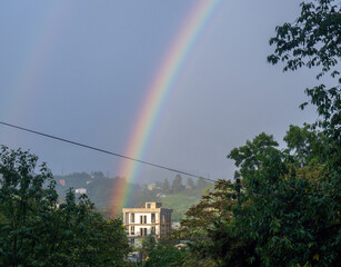Rainbow in the mountains. Rainbow over a house in the mountains. Beautiful and cozy place.