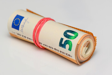 euros rolled into a tube, 50 euro bills on a white background 10