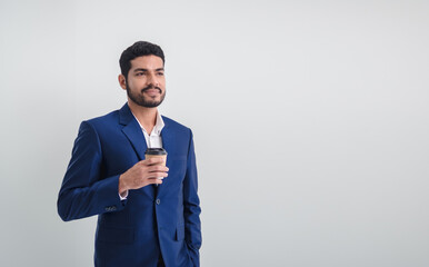 Business man portrait Asian one person wearing a blue suit, handsome cool sharp smart standing looking, hand holding coffee cup paper ready for project work inside the office, with white background