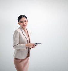 Business woman portrait Asian one person wearing a brown suit, pretty girl cute smart standing looking, hand holding mobile phone and laptop ready for work inside the office, with white background