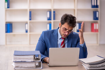 Fototapeta premium Young male employee working in the office