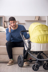Young man looking after newborn at home