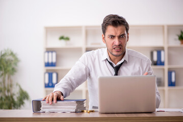 Young male employee working in the office