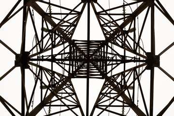 A complex geometric pattern is formed from transverse and vertical blocks of a high-voltage support for transmitting electric current, Kyiv, Ukraine.