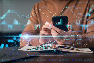Man text send read message on Phone. Holding using smartphone typing at office workplace with notebook. Concept of distant work, business education. Forex market stock and charts, graphs.