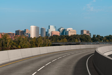 Empty urban asphalt road exterior with city buildings background. New modern highway concrete construction. Concept way to success. Transportation logistic industry fast delivery. Arlington. USA.