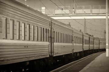 A long-distance passenger train made a stop in a small town, photographed in clear weather in summer, Ukraine.